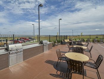 Outdoor Kitchen and Grilling Area with Tables and Chairs