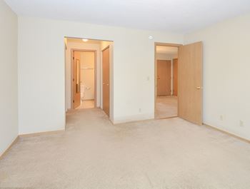 Carpeted Bedroom with Attached Bathroom and Closets