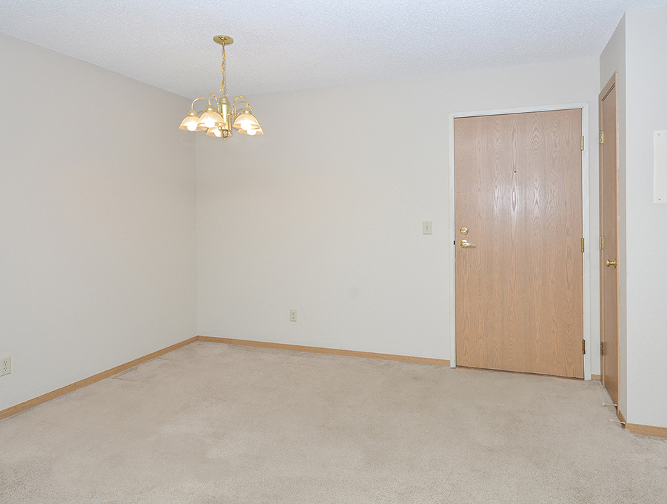 Carpeted Dining Room with Chandelier