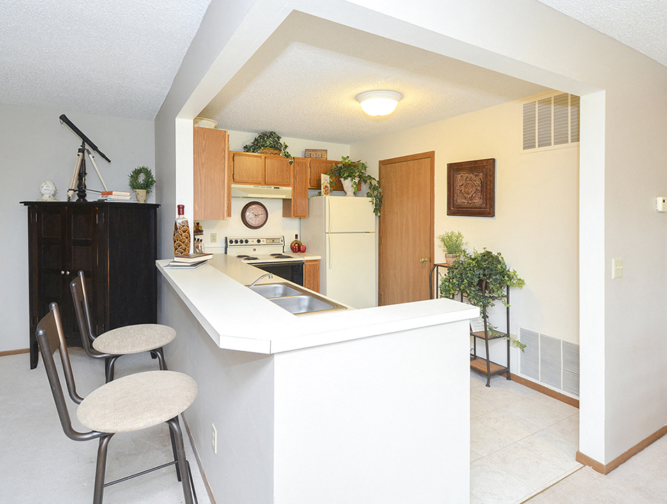 Breakfast Bar in Open Layout Kitchen with White Countertops
