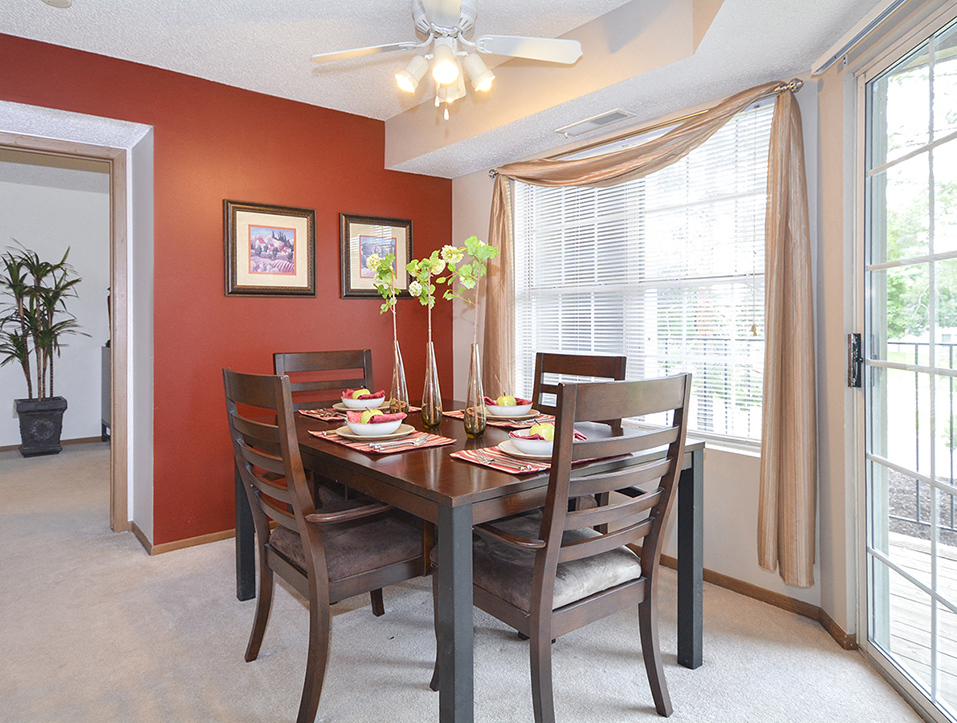 Carpeted Dining room with Large Windows