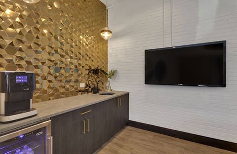 a kitchen with a counter and a tv on the wall
