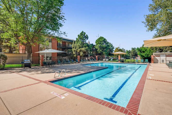 a swimming pool with a building in the background