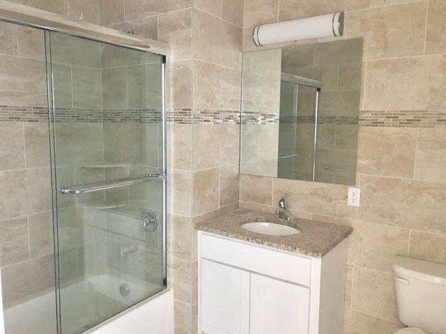 a bathroom with a shower sink and a mirror