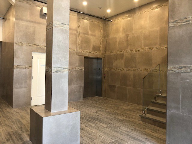 the lobby of a building with a pillar and stairs