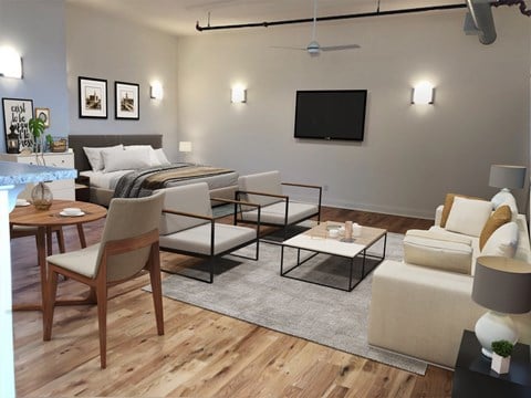 a living room with a bed and a couch and a table