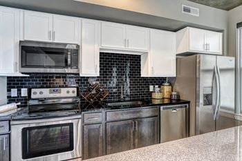 Kitchen with black appliances at Aertson Midtown, Tennessee, 37203