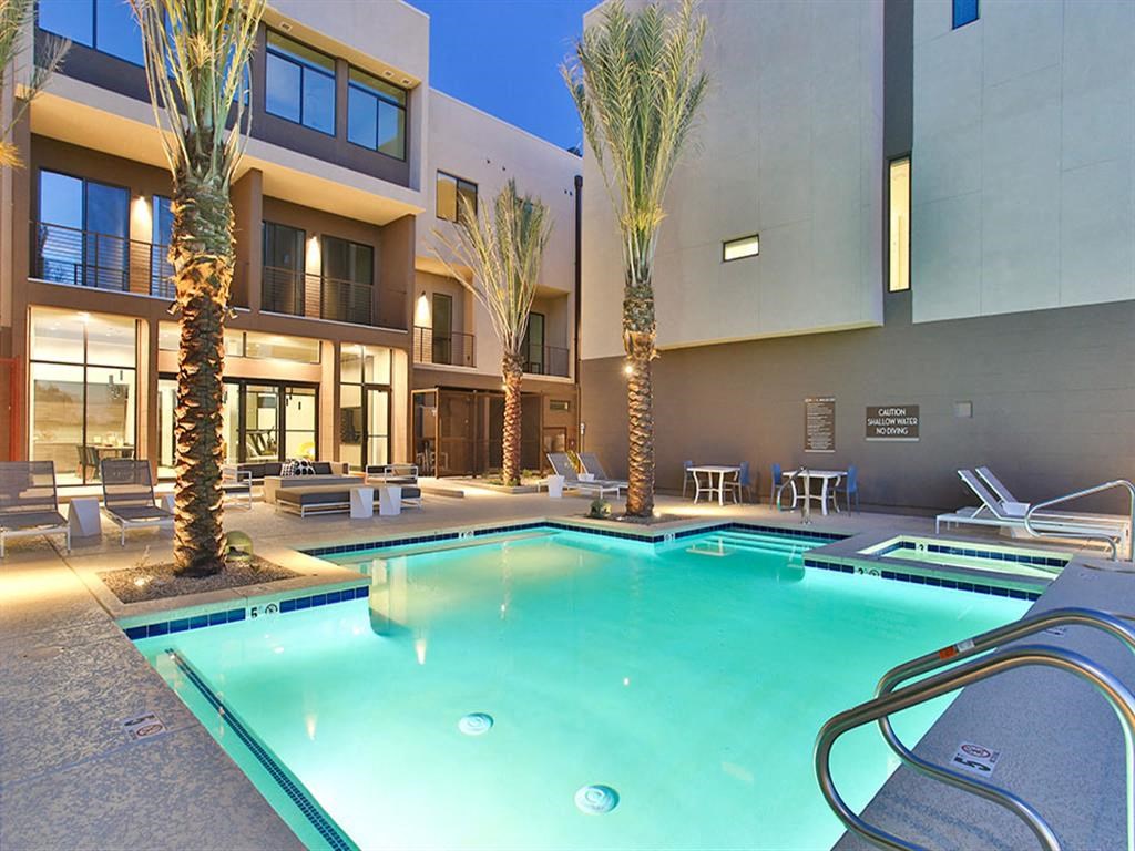Pet-Friendly Apartments in Scottsdale AZ - Dusk Scottsdale - Pool with Tables, Chairs, Lounge Chairs, Fire Pit, Palm Trees, and Spa