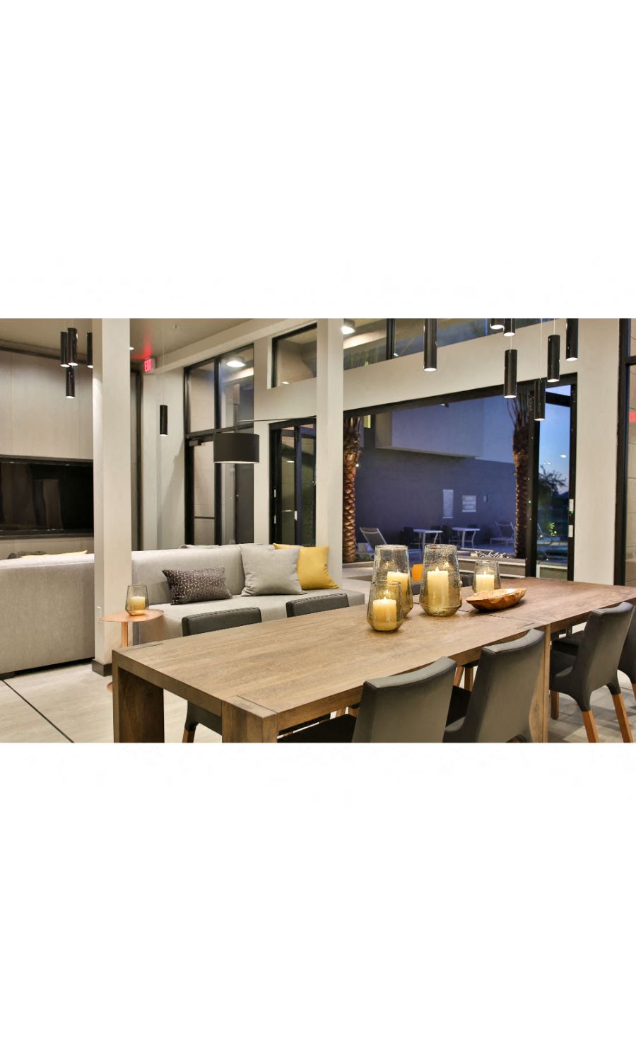 Luxury Apartments Scottsdale-Dusk Scottsdale Clubhouse Next to the Pool with Dining Table and Large Flat Screen TV
