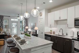 an open kitchen and dining room with a table and chairs