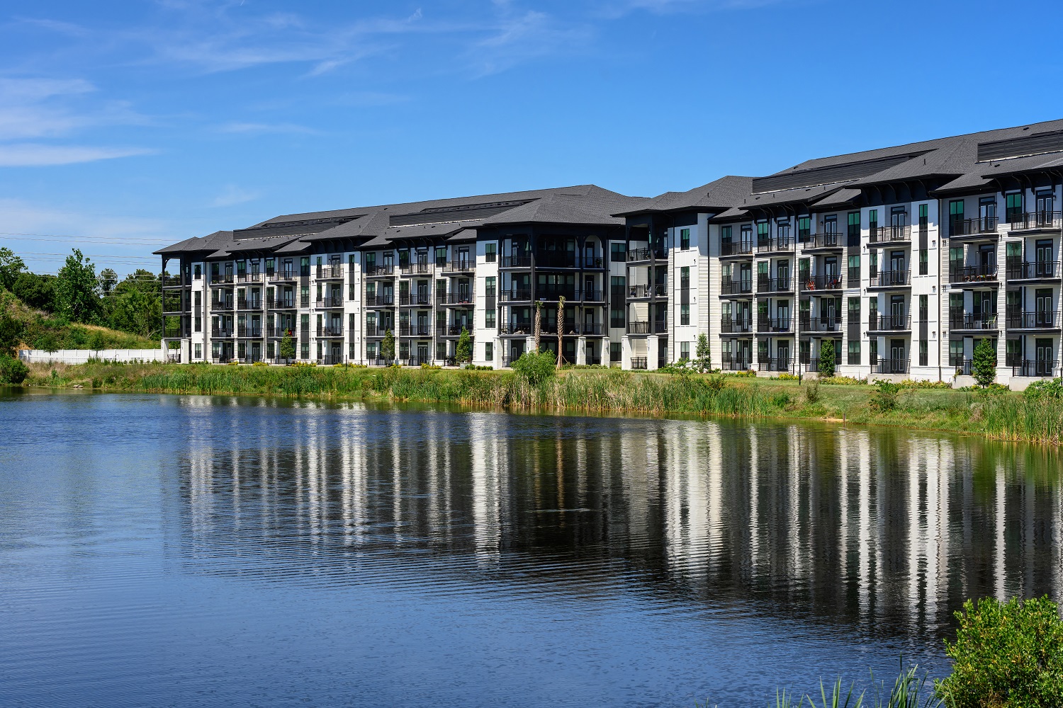 a large apartment building overlooking a body of water