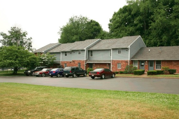 A building with a parking lot in front of it.