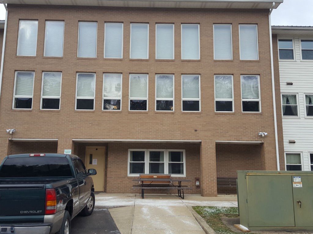 A building with a Chevrolet truck parked in front.