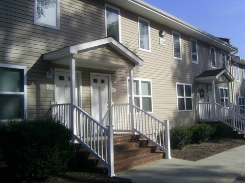 the front of a house with stairs and a porch