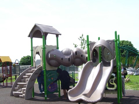 A playground with a slide and a play structure.