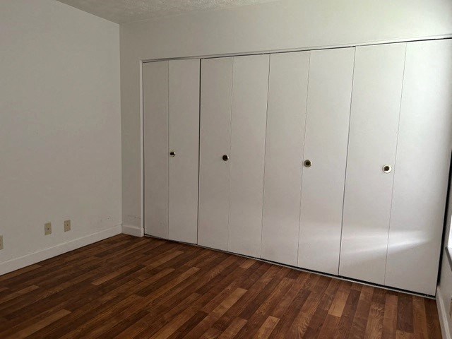 an empty room with white closets on the wall