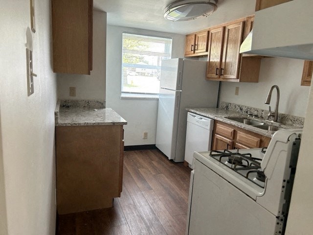 a small kitchen with a stove refrigerator and sink