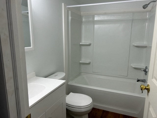 a white bathroom with a toilet and a tub and a sink