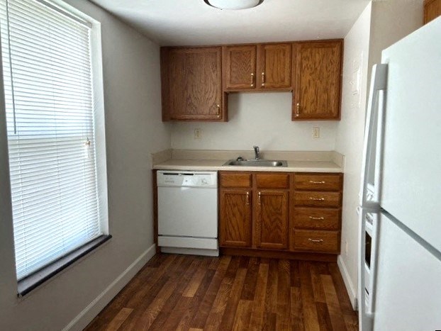 a small kitchen with a sink and a refrigerator