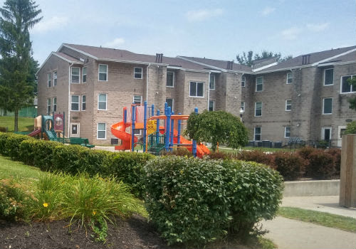 a playground in front of an apartment building