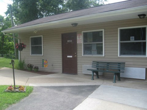 a small house with a bench in front of it