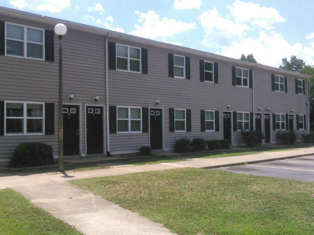 A long building with a lot of windows and doors.