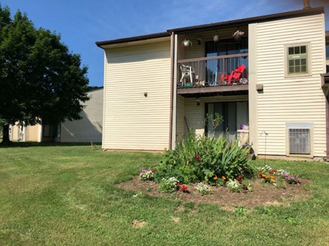 a house with a flower garden in the yard