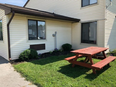 a picnic table in the back yard of a house