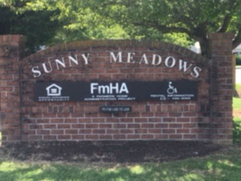 A sign that says Sunny Meadows with a wheelchair symbol on it.