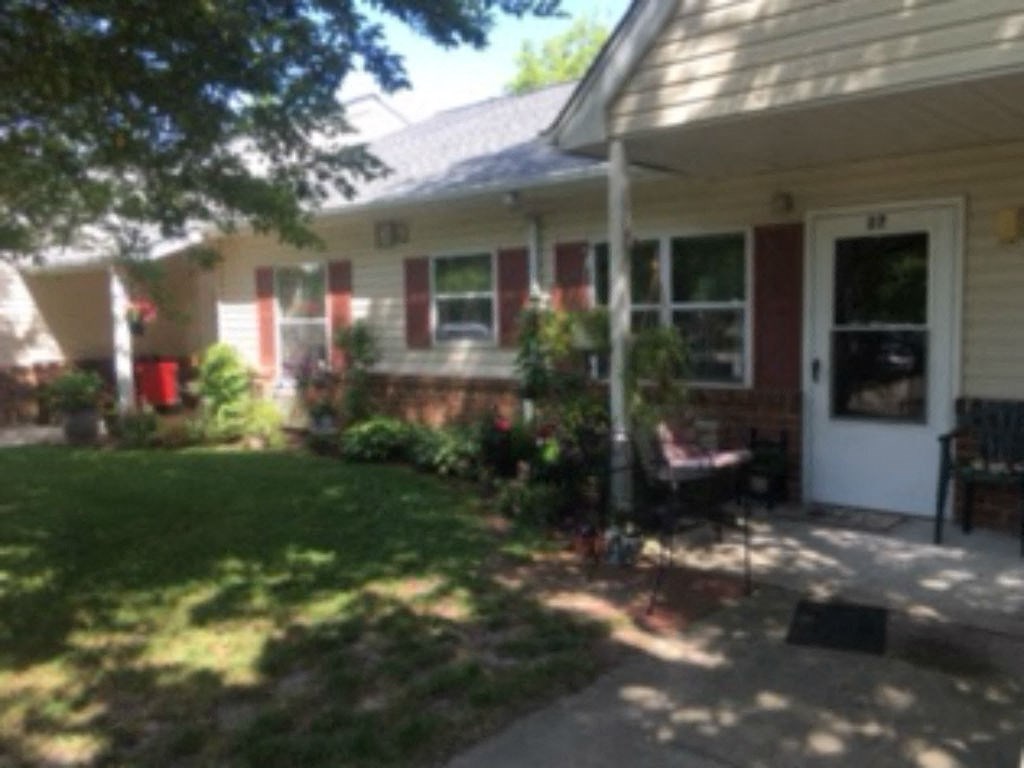 A house with a red door and a white porch.