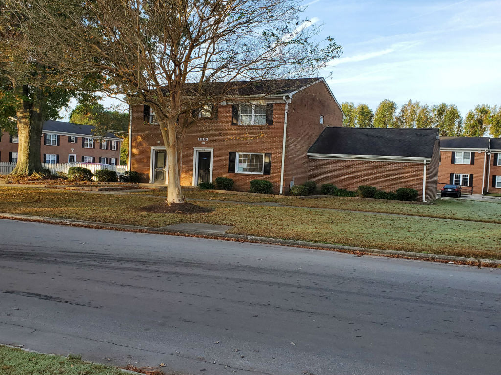 a brick house on the side of a street