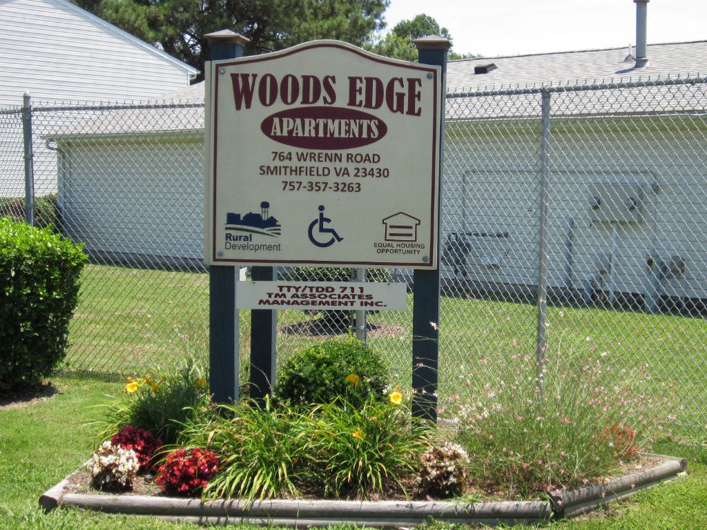the sign is in front of the woods edge apartments sign