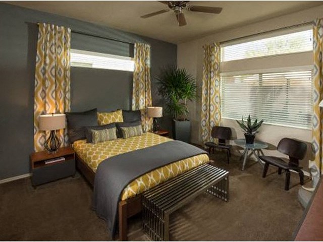 a bedroom with a bed and a ceiling fan