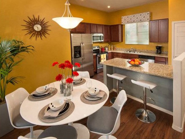 a kitchen and dining room with a table and chairs