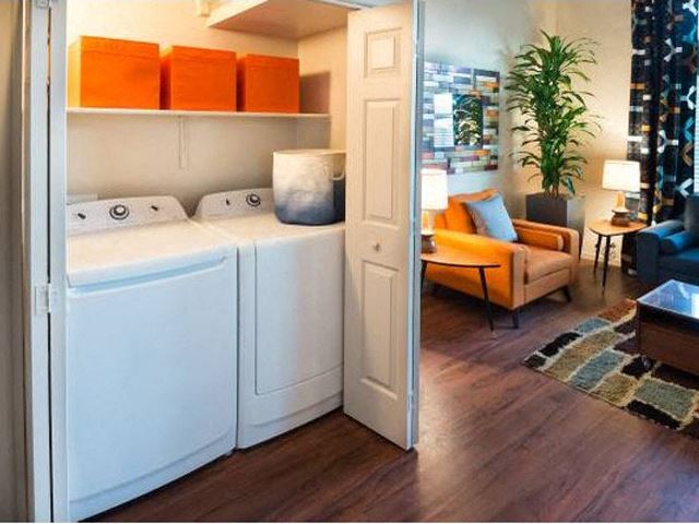 a white washer and dryer in a living room