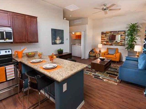 a kitchen and living room with a counter top