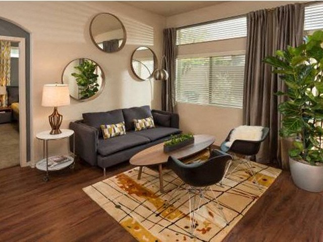 a living room with a couch and chairs and a table