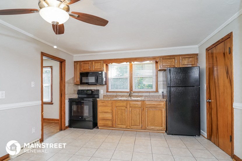 a kitchen with black appliances and wooden cabinets