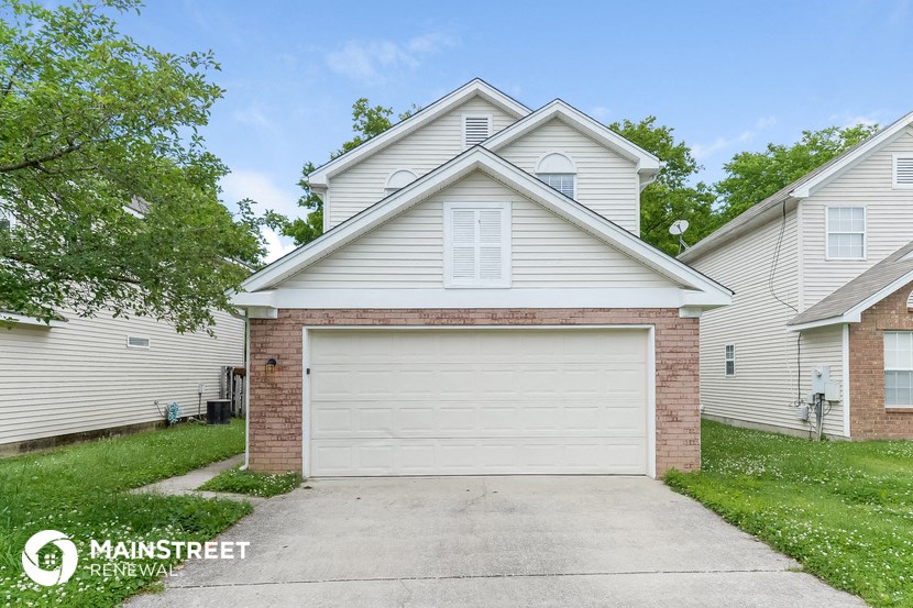 a white garage door in front of a white house