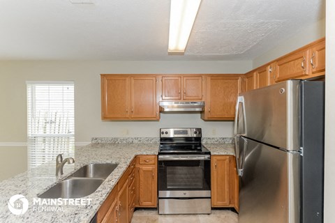 a kitchen with wood cabinets and stainless steel appliances and granite counter tops