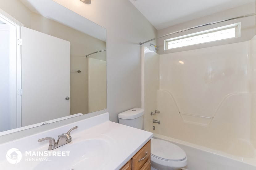 a bathroom with a white sink and a shower and a toilet