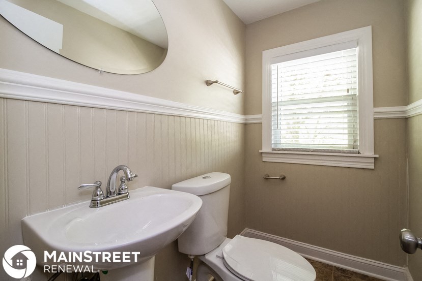 a small bathroom with a sink toilet and a mirror