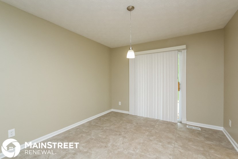 an empty living room with a sliding glass door
