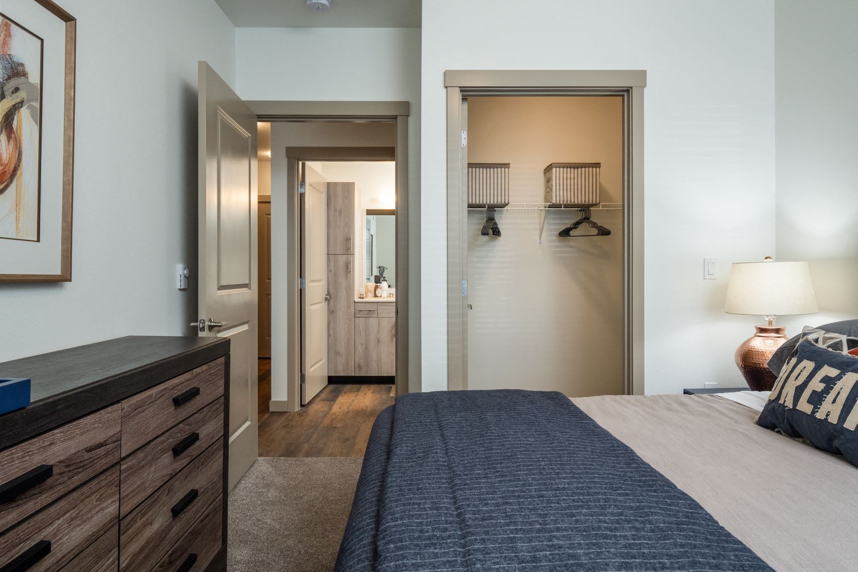 a bedroom with a bed and a closet and a bathroom