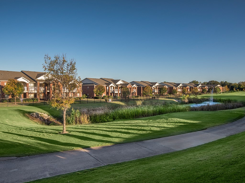 a row of houses on the side of a golf course