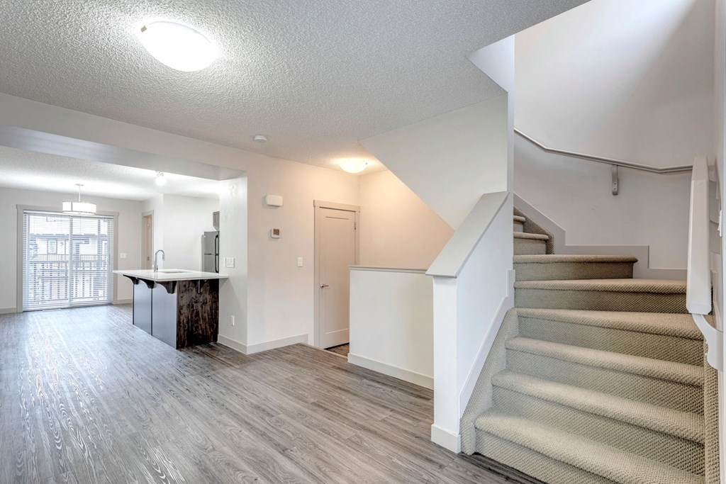 A room with a staircase and a table.