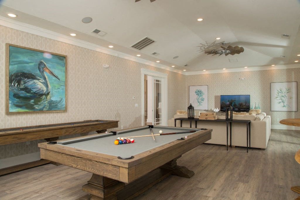 a game room with a pool table and a tv