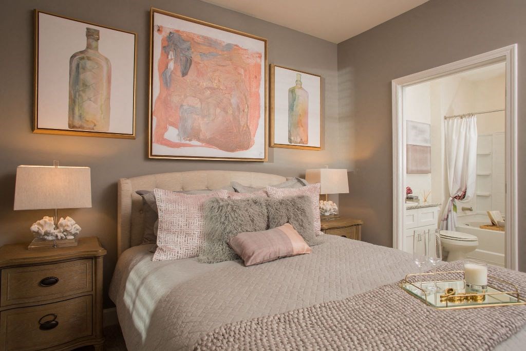 a bedroom with a bed and pictures on the wall