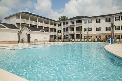 a large swimming pool in front of an apartment building