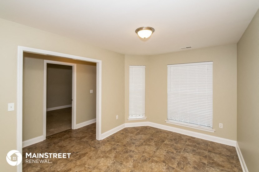 the master bedroom has a large closet and tile flooring
